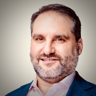 Carlos Miranda Durand, Principal of Proactive Intelligence, smiling in a professional headshot with a neutral background